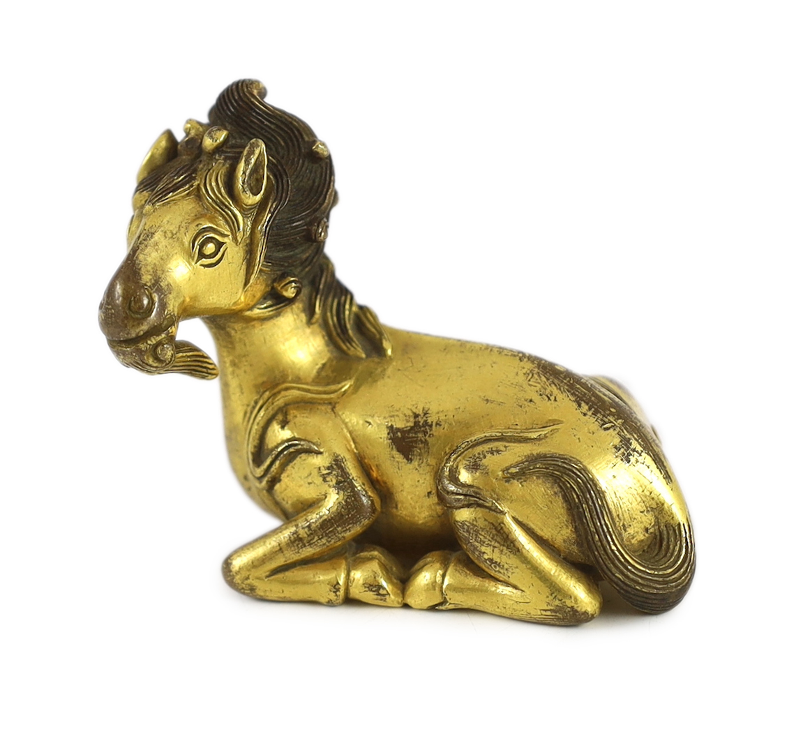 A Chinese gilt bronze qilin scroll weight, 17th/18th century, 7 cm across